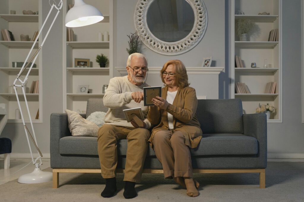 elderly couple in home on sofa