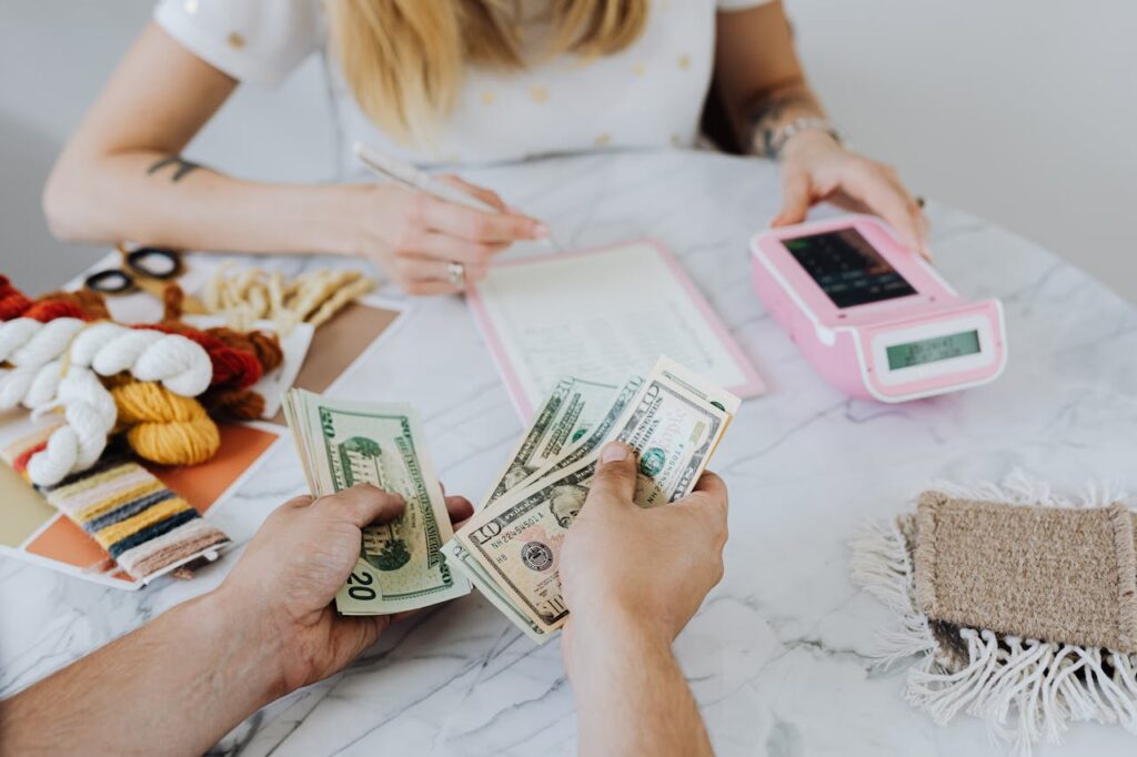 man holding cash in hands and budgeting 