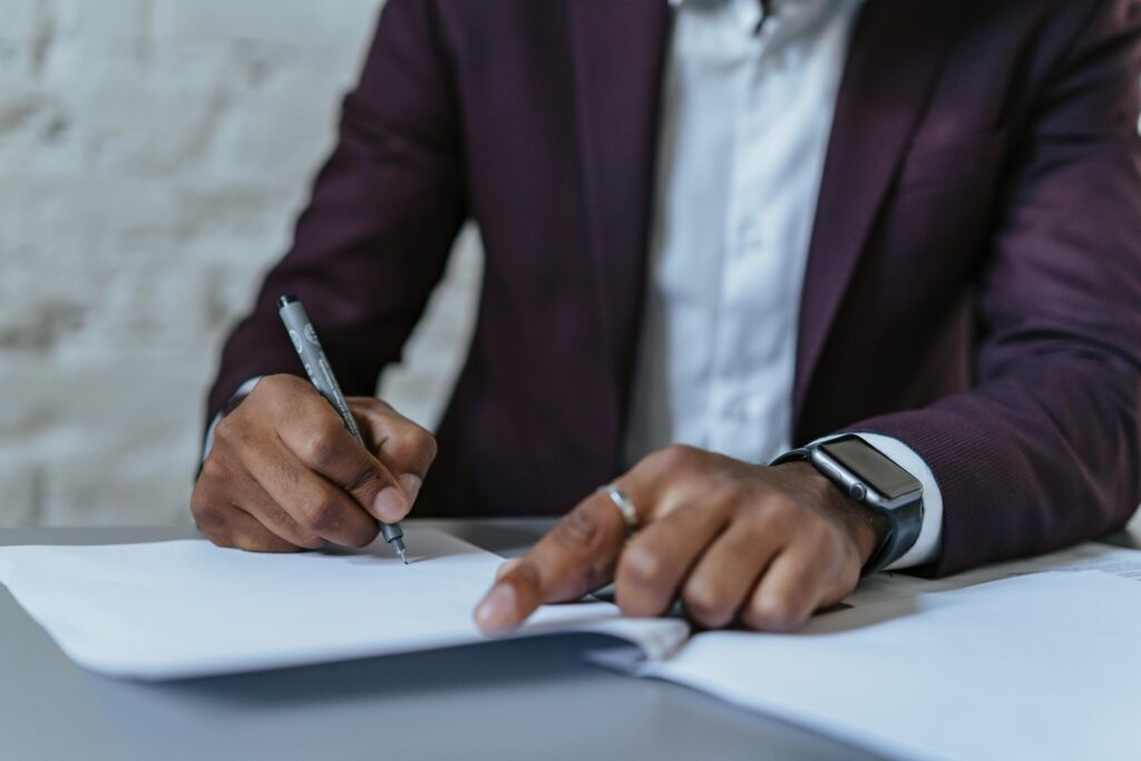 man signing legal forms