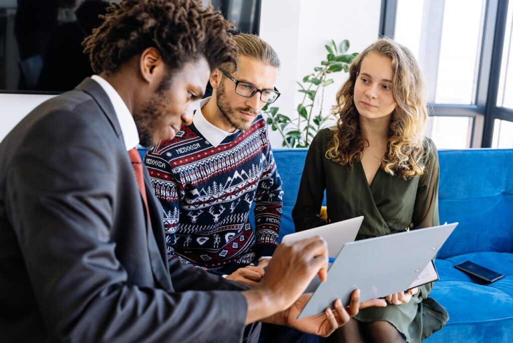 three people looking at paperwork