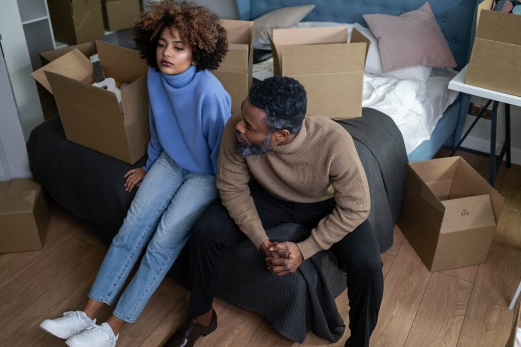 couple on boxes moving out first time buyers